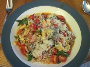 Campanelle with sausage, tomatoes and spinach